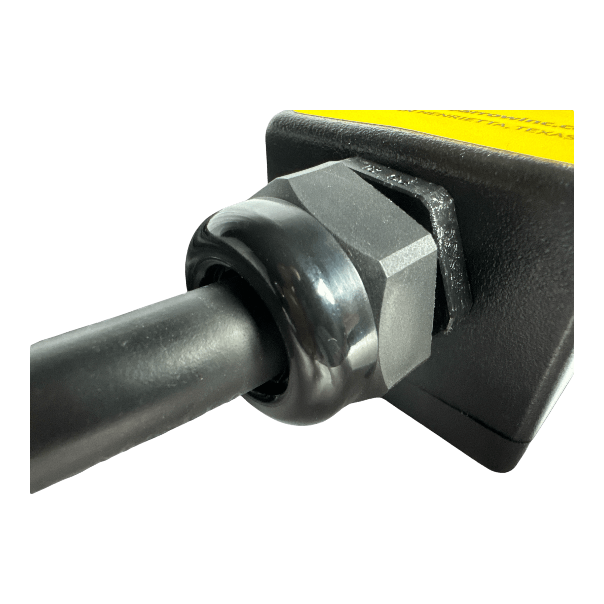 Close-up of a cable connected to the PIERCE 8 Function Wrecker Remote, a black and yellow device with a hexagonal nut, commonly used in solenoid systems in the towing industry.