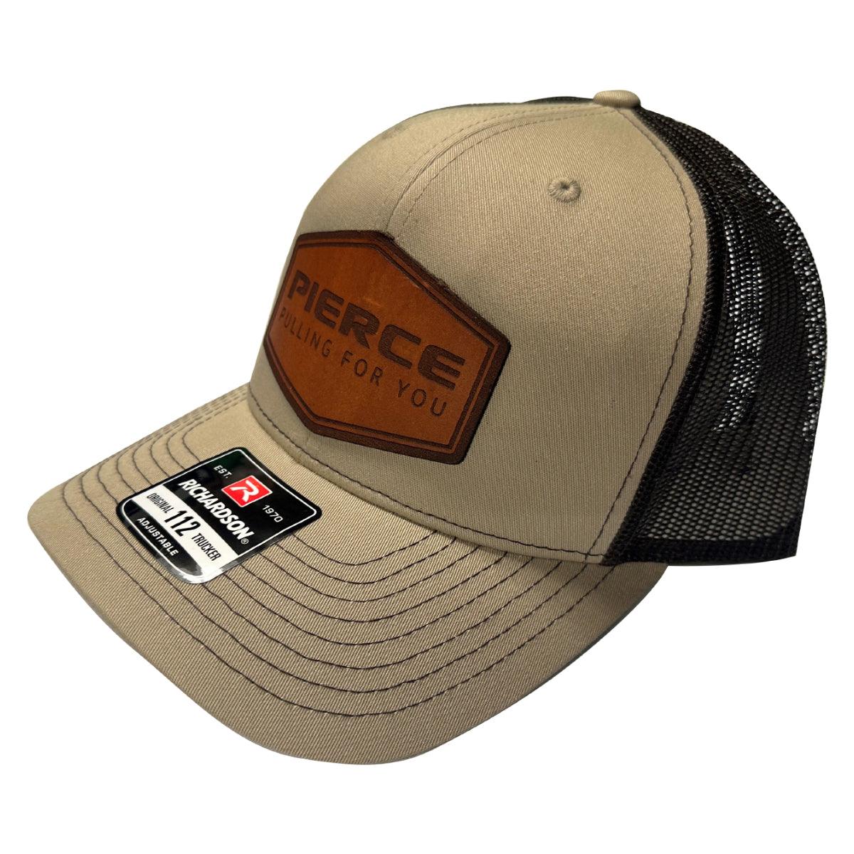 Tan trucker cap from PIERCE's stylish Richardson 112 hat collection, showcasing "PIERCE" and "Pulling For You" on a leather patch.