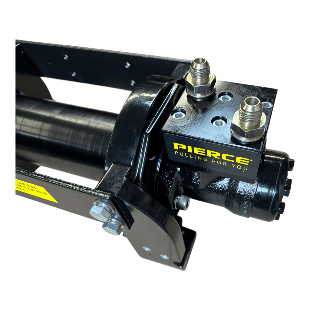 Close-up of a black 10,000 lb Hydraulic Recovery Winch by Internal - Pierce Assembly Team, featuring a "PIERCE PULLING FOR YOU" label and metal fittings for industrial recovery tasks.