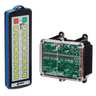The 16 Function IP Wireless Control System, part of the 92 Series from Lodar LTD, includes a transmitter with 16 functionalities. This device has buttons positioned alongside a circuit board in a transparent casing, making it ideal for controlling solenoid operated equipment within an industrial wireless control system.