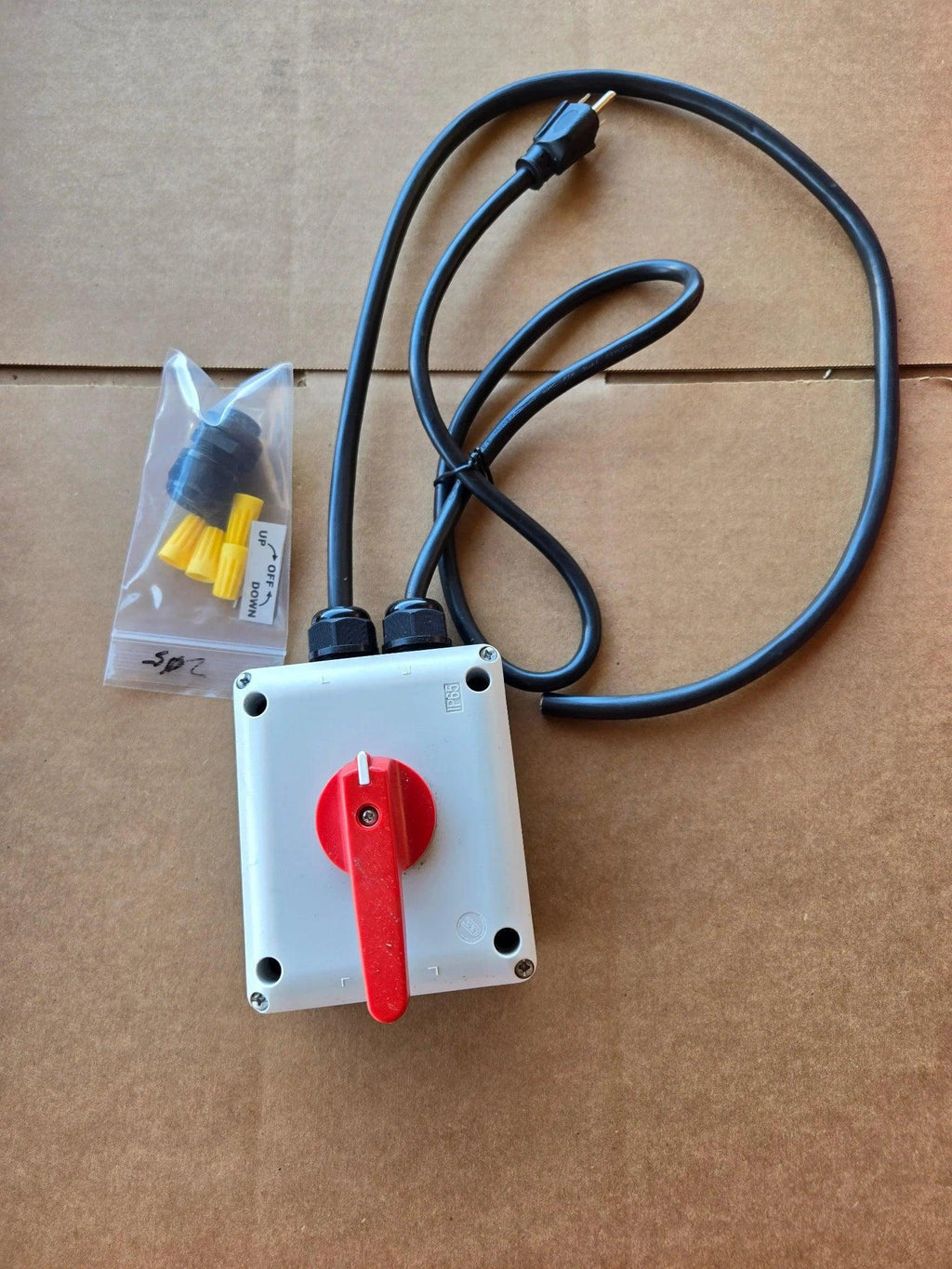 The PIERCE Wired Control for 110V 654 Series Single Phase Winch features a red handle, black cable, and sealed wire connectors in an IP65 thermoplastic enclosure for reliable motor control.