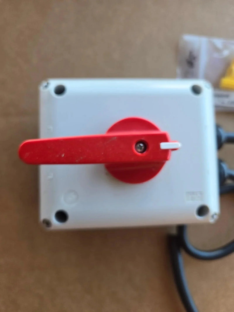 A PIERCE Wired Control for 110V 654 Series Single Phase Winch in a white IP65 thermoplastic enclosure with a red rotary switch is shown mounted on a brown surface—ideal for reliable winch operation.