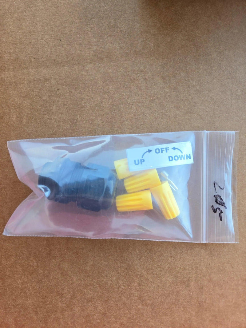 A clear bag holds black and yellow plastic parts for the PIERCE Wired Control, 110V 654 Series Single Phase Winch, plus a UP OFF DOWN label for easy motor operation.