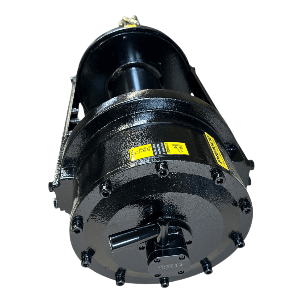 The Internal - Pierce Assembly Team’s 20,000 lb Hydraulic Recovery Winch (Long Drum, Manual Clutch) features a black industrial drum with bolts and yellow caution labels, viewed from a low front angle.