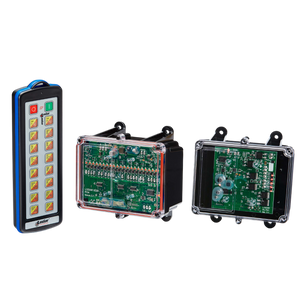 Against a sleek black backdrop rests a sophisticated 24 Function controller, accompanied by its remote control and two electronic circuit boards encased in transparent covers. This arrangement showcases the advanced capabilities of Lodar LTD's 92 Series IP SHIFT Wireless Control System, expertly incorporating cutting-edge firmware technology for precise operation.