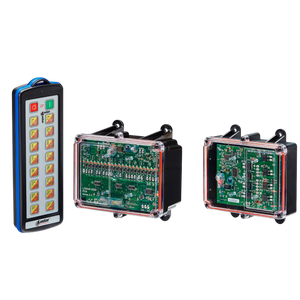 A 26 Function IP SHIFT Wireless Control System featuring a Lodar LTD controller with 16 buttons and two electronic circuit boards in transparent cases lies on a black background, highlighting the efficiency of the Lodar LTD system.
