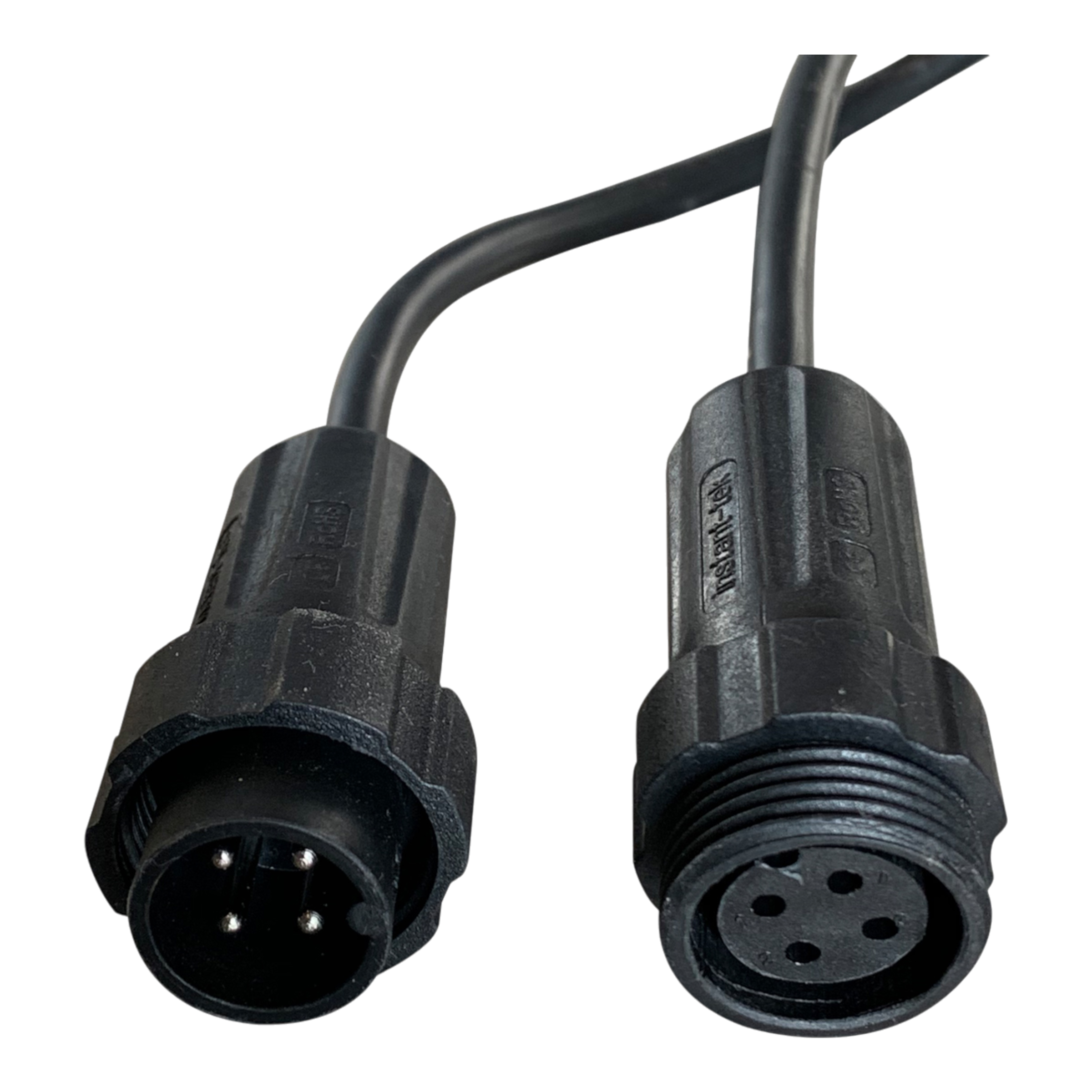 Two black connectors with multiple pins from the PIERCE 2 Function Wireless Control System for Dump Trailer are positioned on a black background, showcasing both ends and reflecting the precision engineering typical of hydraulic pumps.