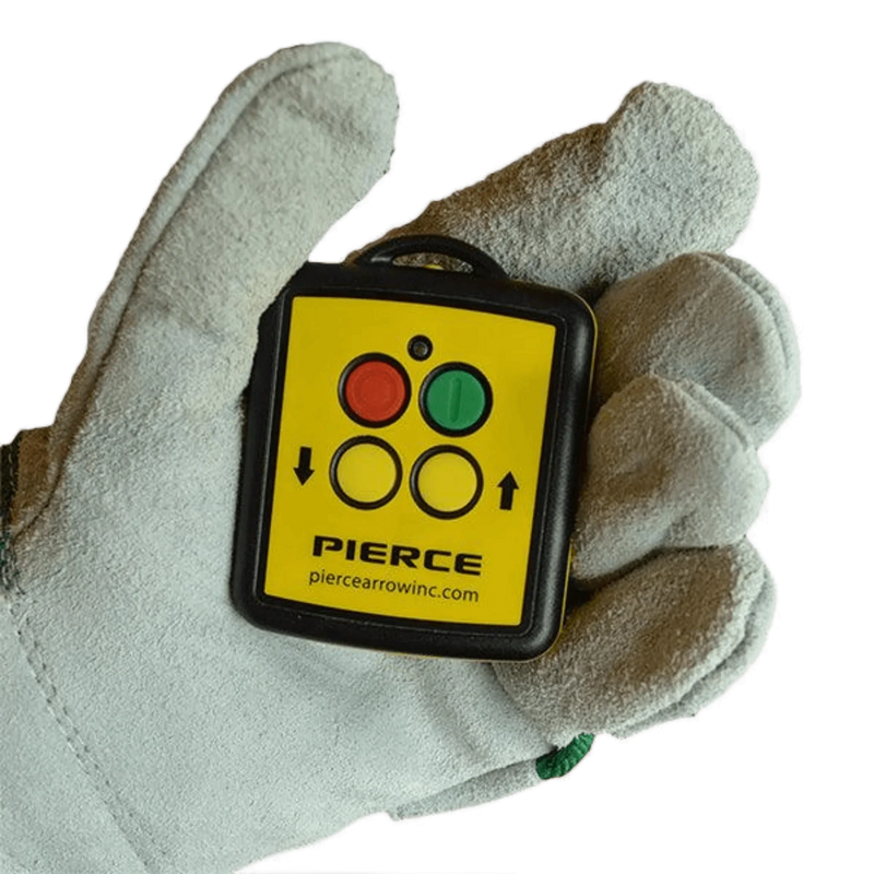 A gloved hand holds a Lodar LTD 2 Function Wireless Remote Control System with red and green buttons and arrow symbols, designed for 12/24V solenoid-operated equipment at 433 MHz.