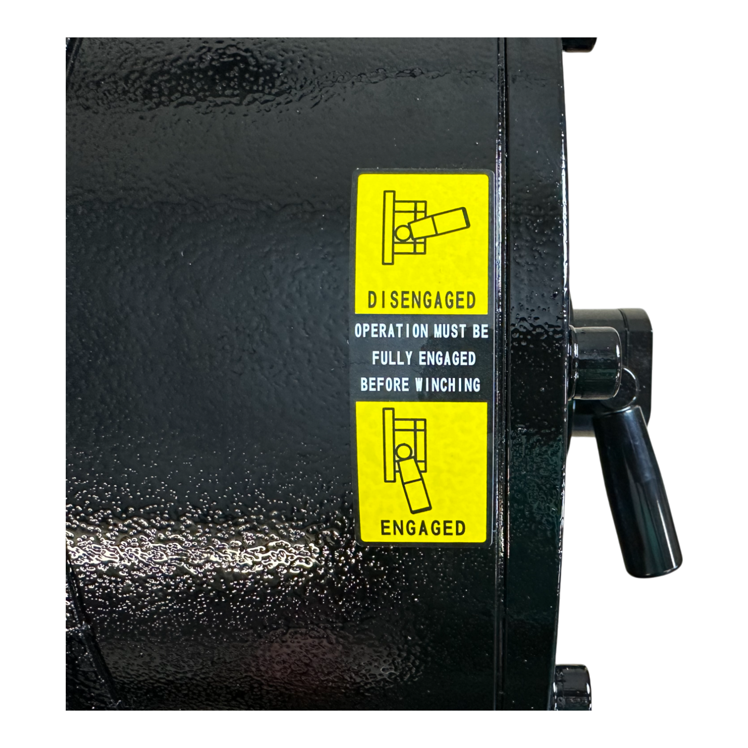 Close-up of the PIERCE 30,000 lb Hydraulic Recovery Winch with Long Drum and Manual Clutch displaying a yellow label that details Engaged and Disengaged instructions. The robust design includes a planetary gear system, ensuring efficient operation that effortlessly handles loads up to 30,000 lb.