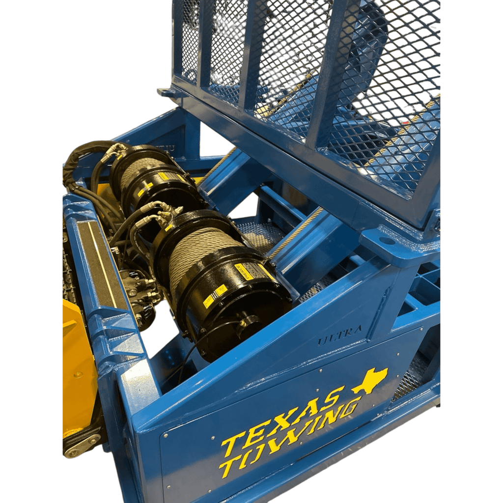 PIERCE 30,000 lb Hydraulic Recovery Winch with narrow drum and air clutch is mounted on a blue tow truck with TEXAS TOWING text and yellow state outline; metal mesh above ensures reliable, heavy-duty towing performance.