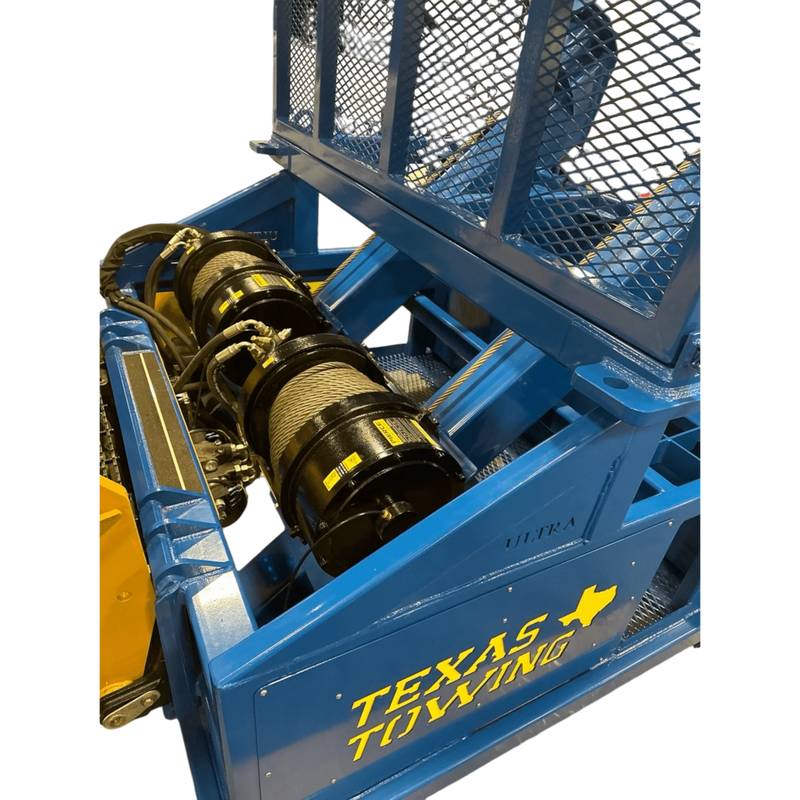 PIERCE 30,000 lb Hydraulic Recovery Winch with narrow drum and air clutch is mounted on a blue tow truck with TEXAS TOWING text and yellow state outline; metal mesh above ensures reliable, heavy-duty towing performance.