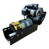 The PIERCE 110V Electric Winch (7,500 lb, 8" split drum) by PIERCE features dual pull points, a yellow label, and is mounted on a black metal base, shown from the front.
