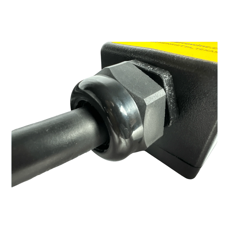 Close-up of a black cable secured with a plastic cable gland to the PIERCE 8 Function Wrecker Remote, commonly used in 12/24V solenoid systems or hydraulic power units.