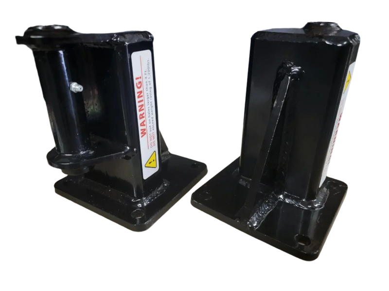 The PIERCE Bale Unroller Extension Set features two black metal brackets with warning labels on square bases, designed for 4-foot round hay bales and compatible with hay bale unroller extensions, shown against a white background.