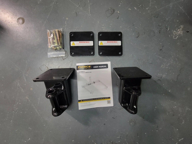 The PIERCE Bale Unroller Extension Set includes two black metal brackets, two plates, screws, and a user manual—perfect for efficiently installing extensions to handle 4-foot round hay bales.