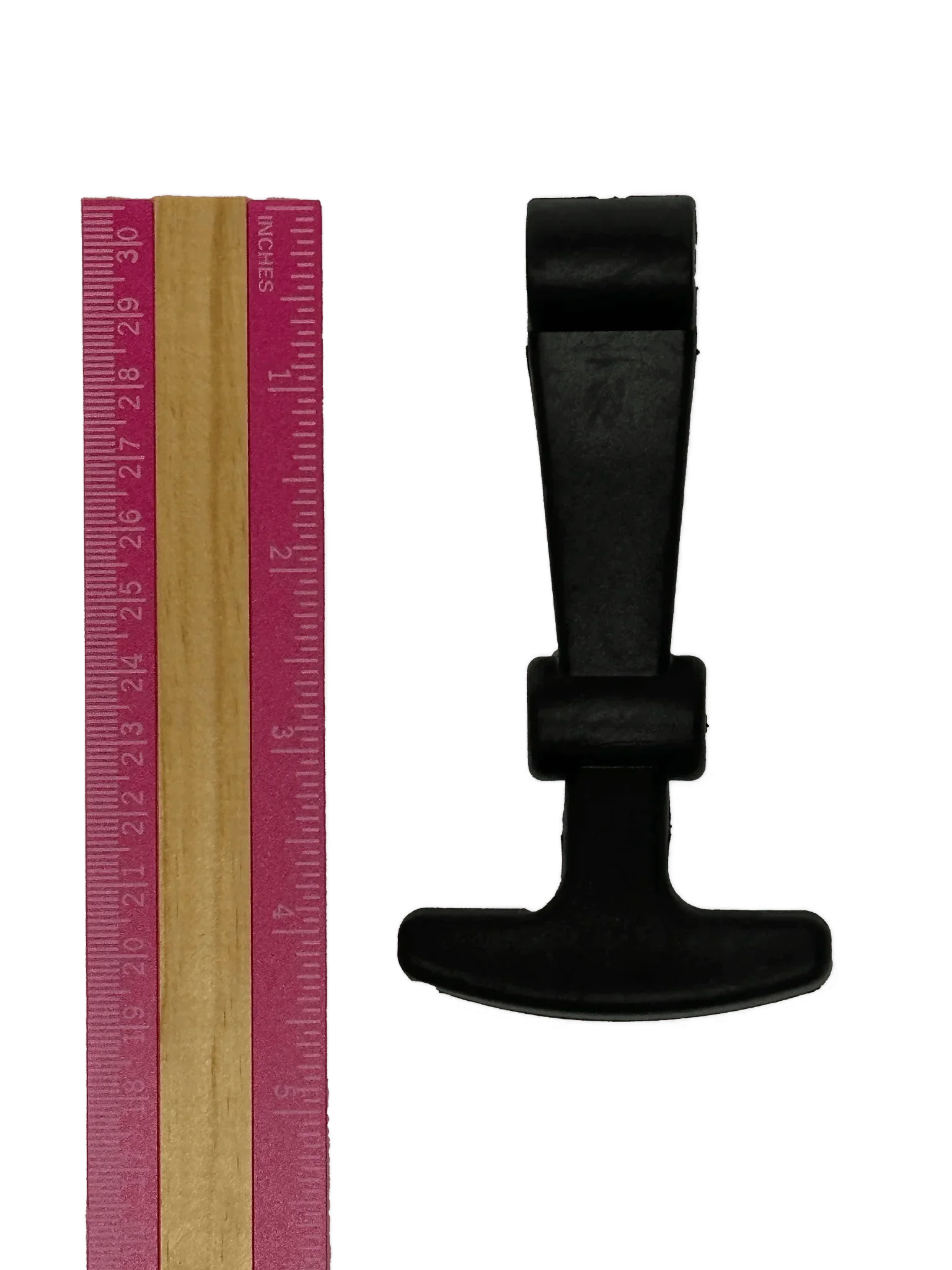 A pink ruler is placed beside a black, T-shaped PIERCE Coolers | Latch on a white background.