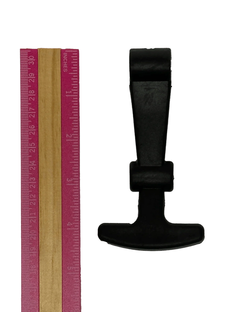 A pink ruler is placed beside a black, T-shaped PIERCE Coolers | Latch on a white background.