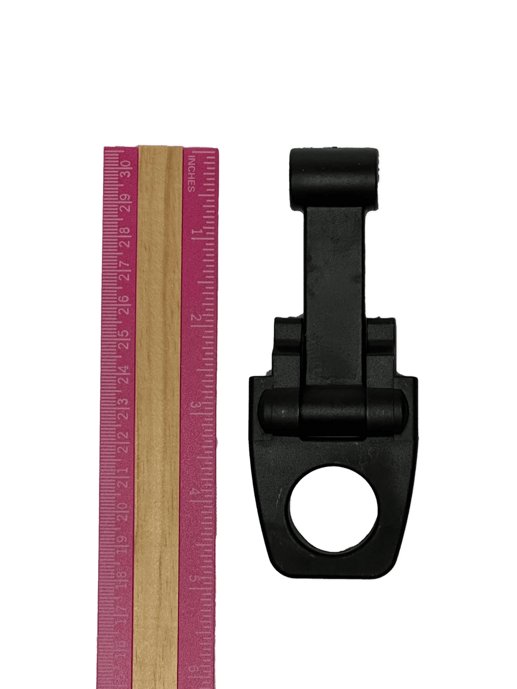 A pink ruler and a PIERCE Coolers Latch Version 2 in black plastic with a round hole, both on a white background.