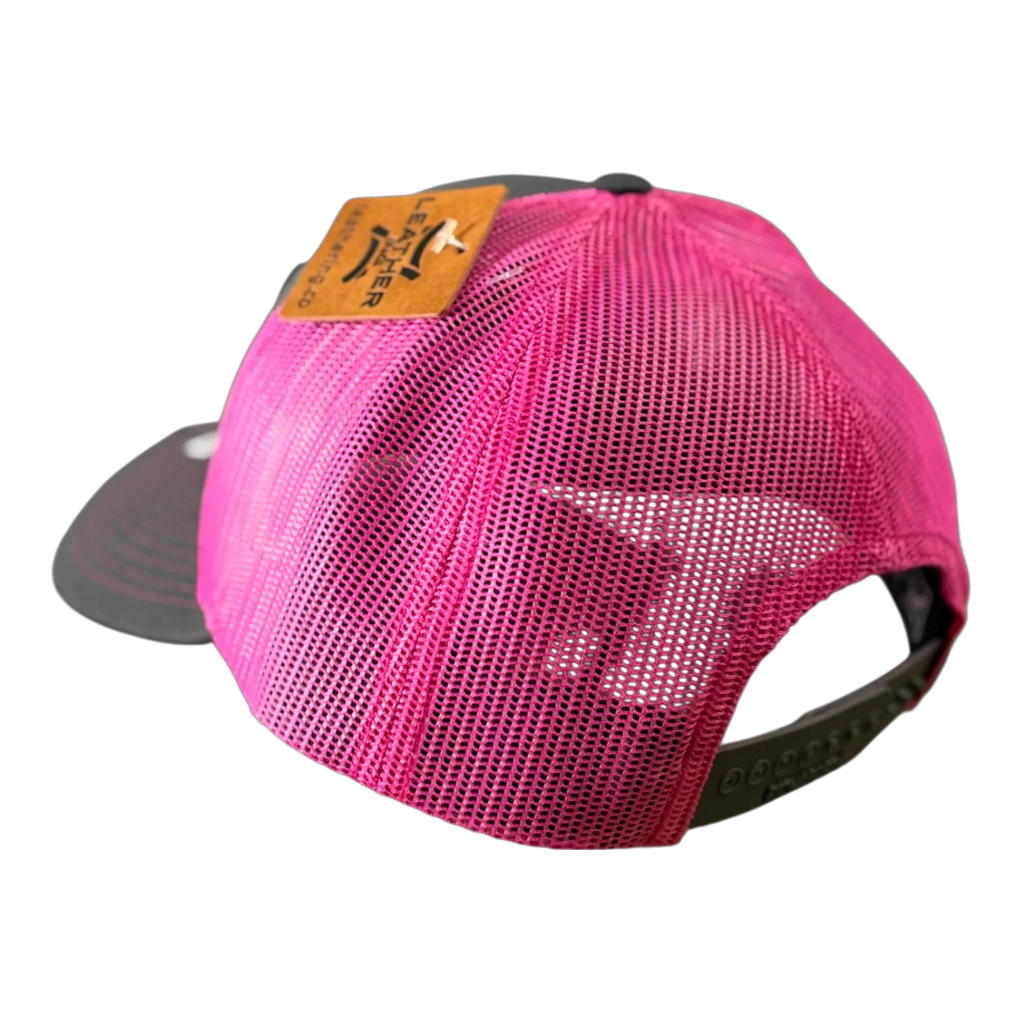 The PIERCE VAXMATE Trucker Hat with Leather Patch in pink mesh is shown from the back, highlighting its adjustable snap closure and brown ear tag patch.