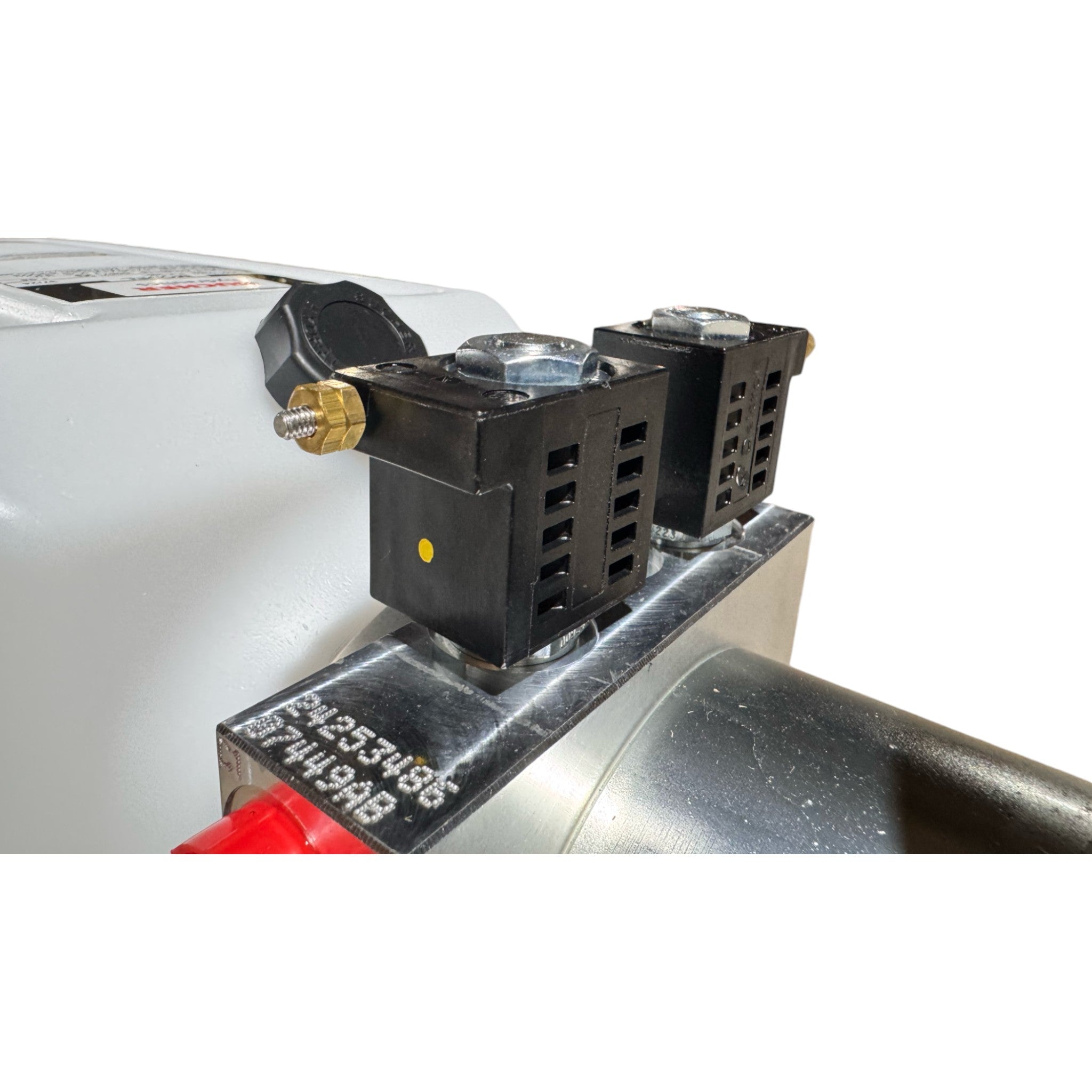 Close-up of an industrial metal machine featuring two black electrical components, a silver pipe, and a Bucher Hydraulics, Inc. Bucher Pump 2 Way (Power Up / Power Down) with 2.5 gal. poly reservoir.
