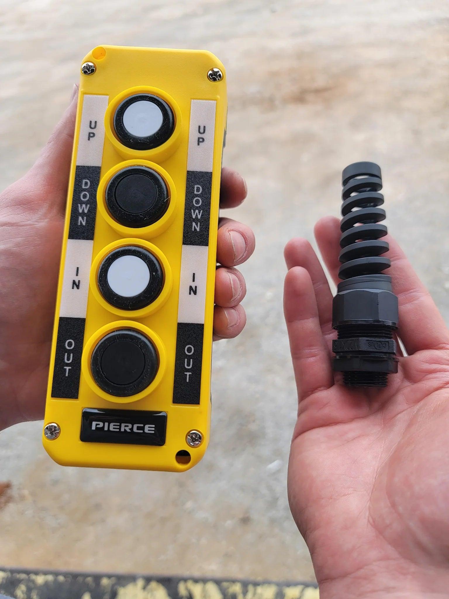A hand holds the Asetek Enterprise Company LTD Universal Momentary Pendant Control - 4 Button; another hand holds a black part—ideal for hydraulic power packs in industrial applications.
