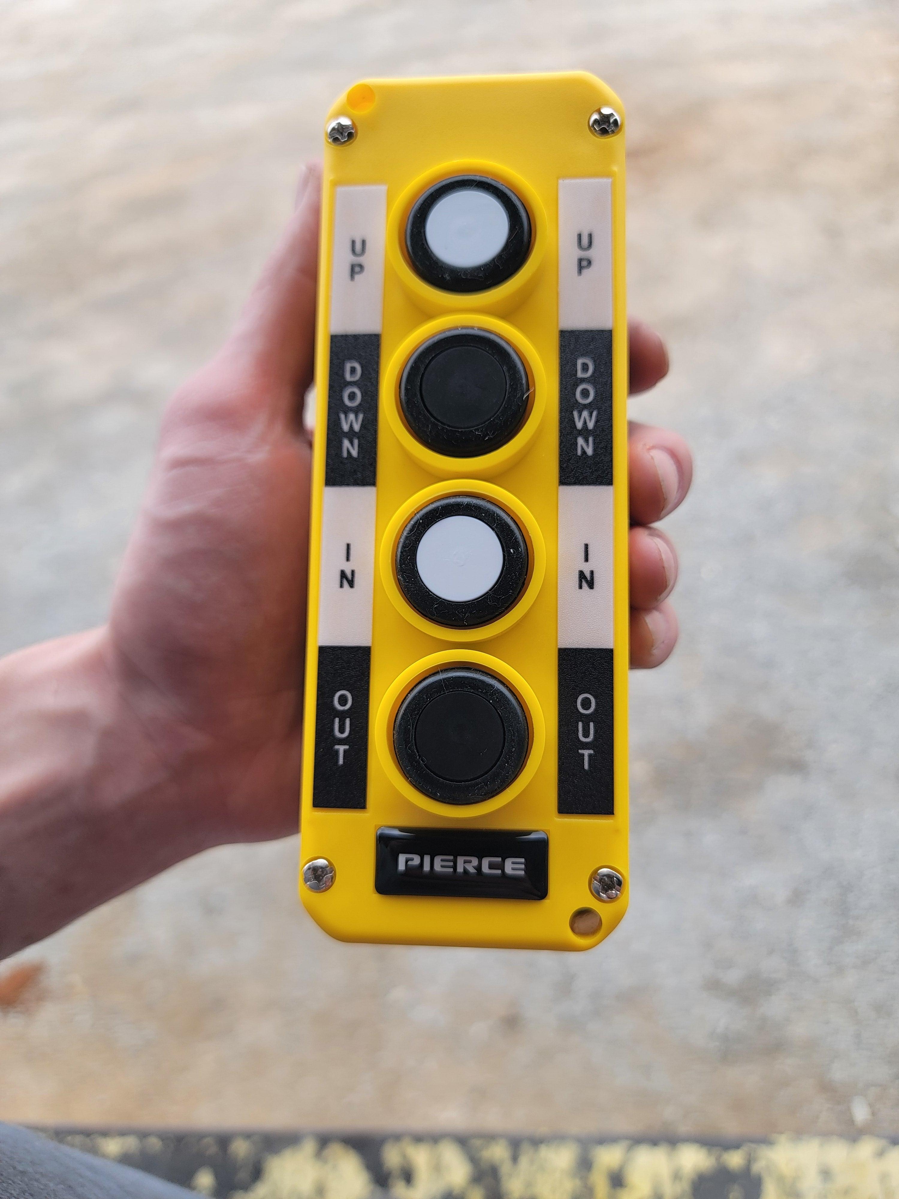 A hand holds the Asetek Enterprise Company LTD Universal Momentary Pendant Control - 4 Button, featuring yellow casing and black buttons, suitable for hydraulic power packs and industrial use.