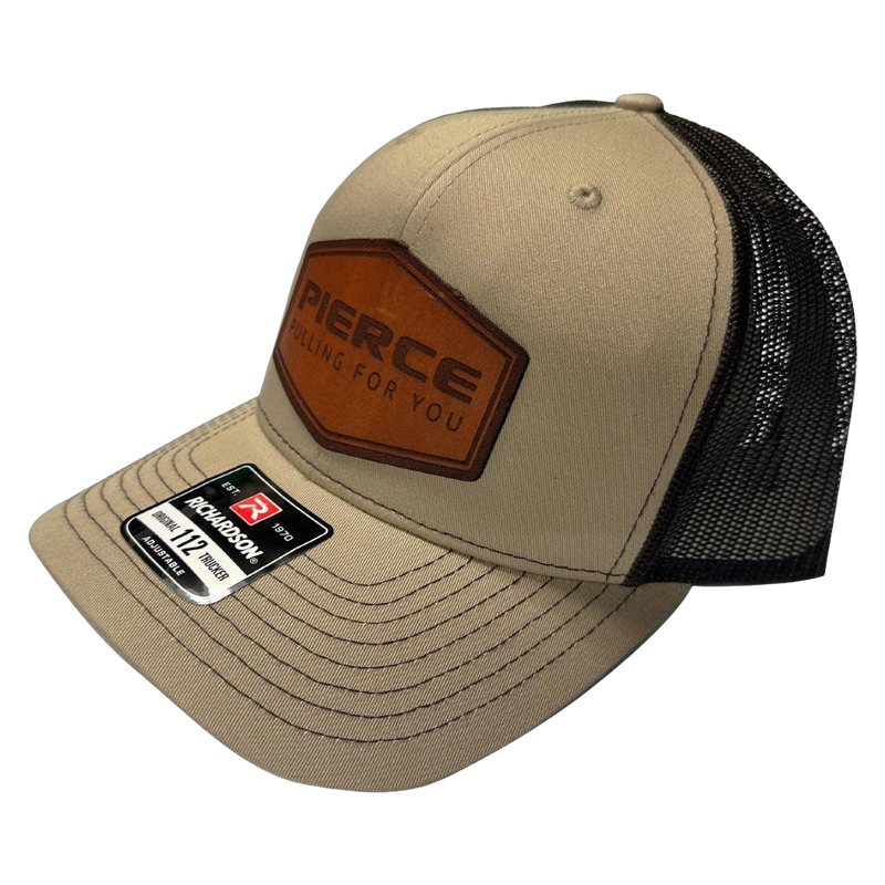 Tan trucker cap from PIERCE's stylish Richardson 112 hat collection, showcasing "PIERCE" and "Pulling For You" on a leather patch.